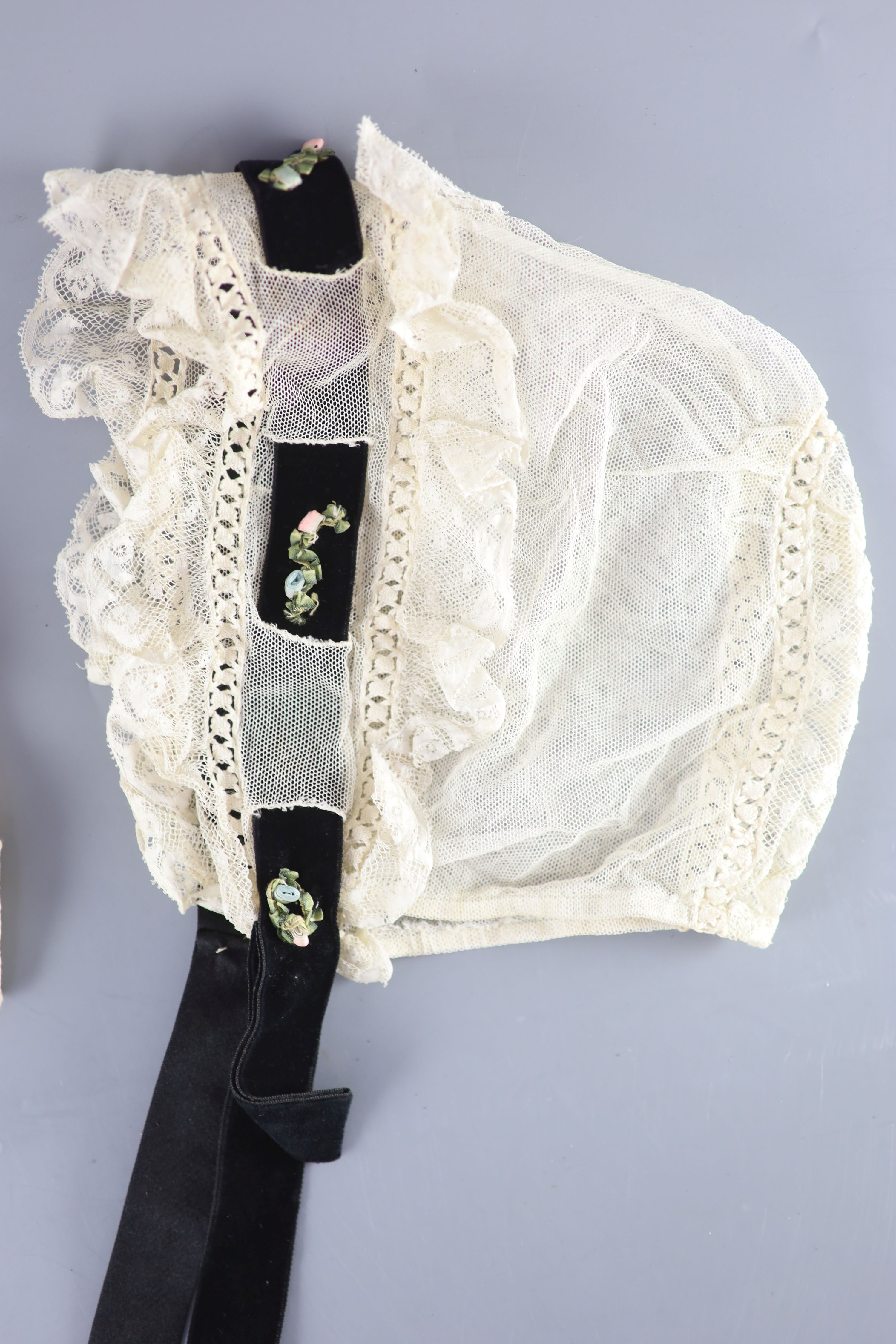 A fine white worked embroidered lace inset coverlet, a filet lace square of a figure wearing a crown (plus museum note),